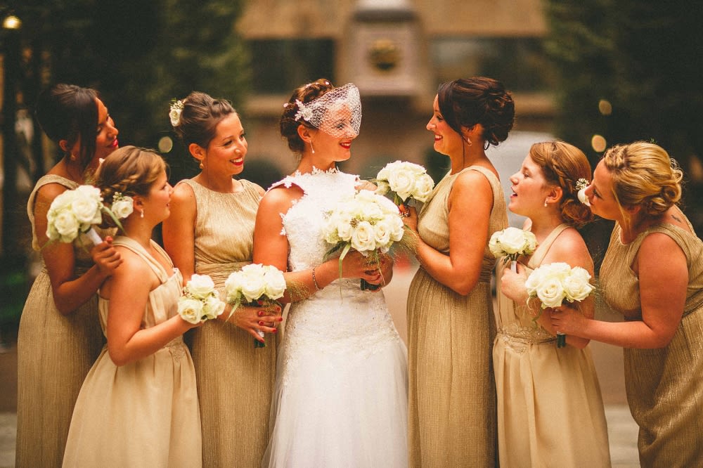 Bridebook.co.uk- bride bridesmaids and flower girl in gold dresses