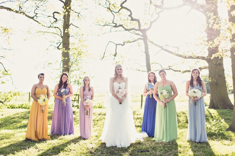 Bridebook.co.uk- bride and bridesmaids in mismatched dresses