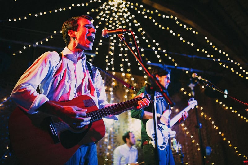 Bridebook.co.uk- wedding band playing at reception with the guitarist singing