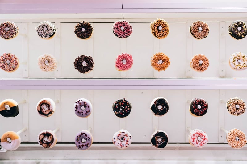 Doughnut wall holding plenty of tasty doughnuts of different flavours at wedding