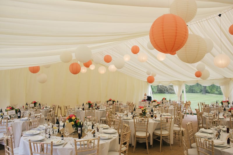 paper lanterns hanging in a marquee set up for a wedding breakfast