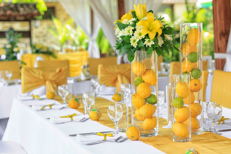 lemons in glass vases as table decor at a wedding
