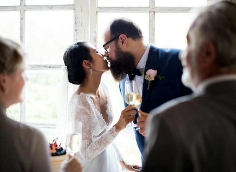 Couple kissing and toasting 