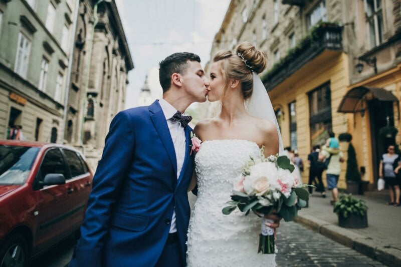 Married couple kissing in the street