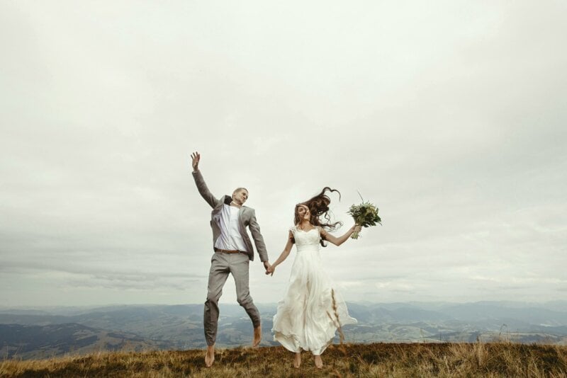 Jumping married couple outdoor