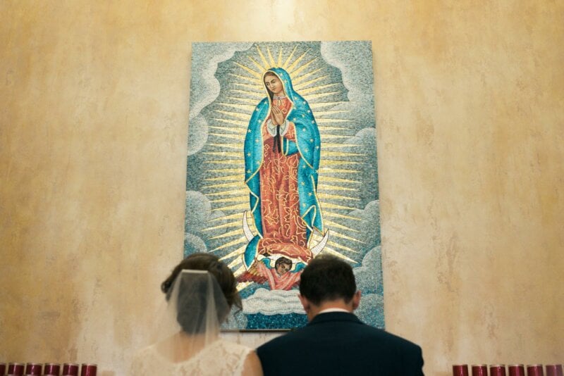 Couple praying during their wedding