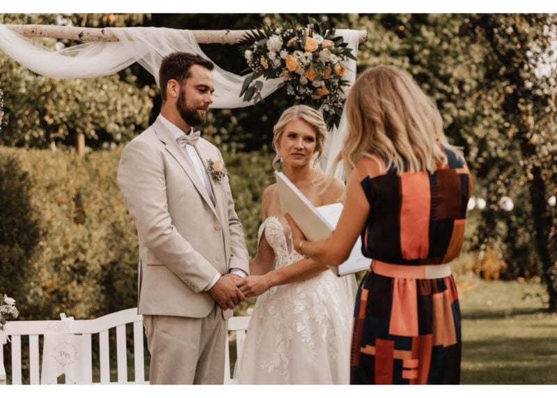 Freie Traurednerin liest eine Fürbitte zur Hochzeit bei einer Zeremonie im Freien vor