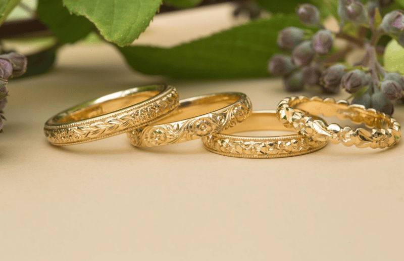 Gold wedding bands displayed in a row