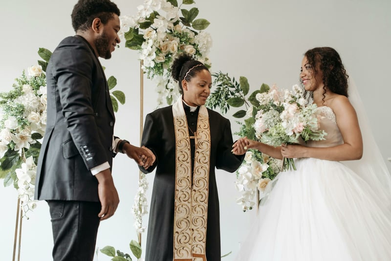 couple getting married by a vicar in a religious wedding ceremony