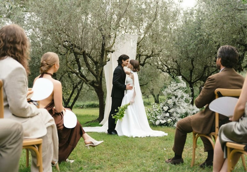 Couple kissing at an outdoor wedding ceremony