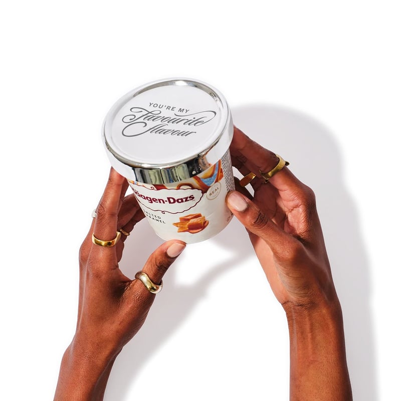 Hands holding an ice cream tub with a personalised silver lid