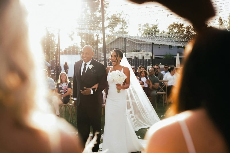 Bride being walked down the aisle on her wedding day