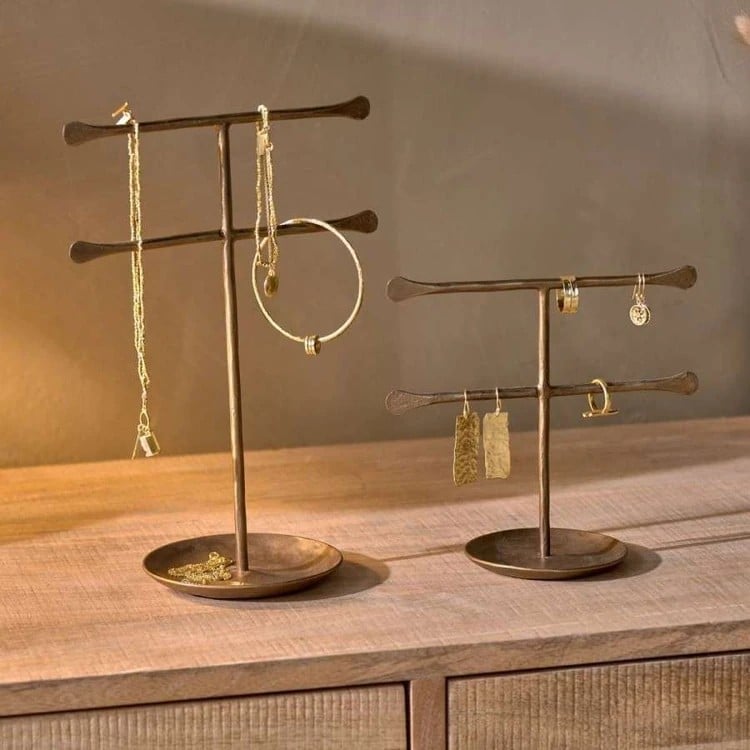 brass jewellery stand on an oak cabinet