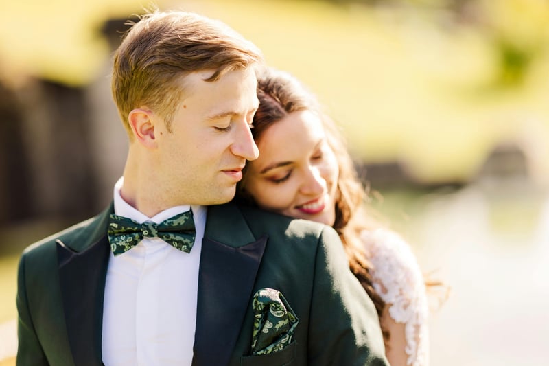 Bride resting her head on the shoulder of her groom at their wedding