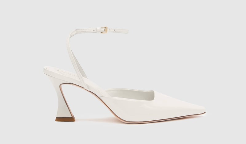 a white leather pointed slingback pump with ankle strap