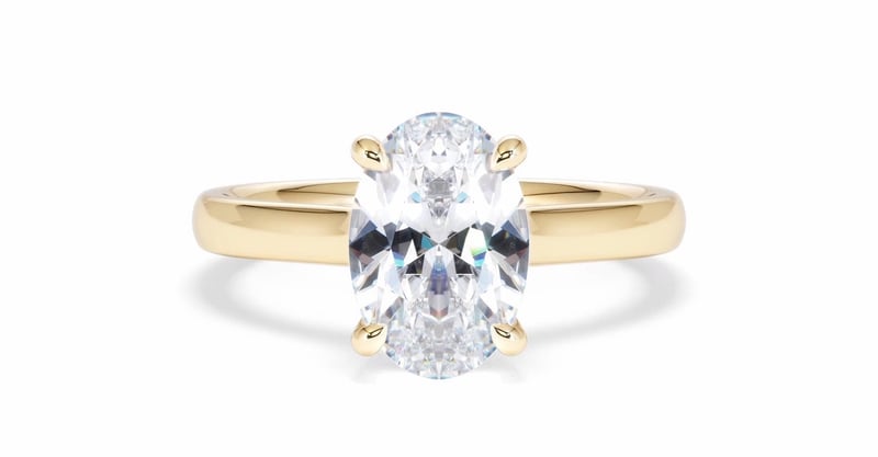 a yellow gold engagement ring with oval-cut diamond