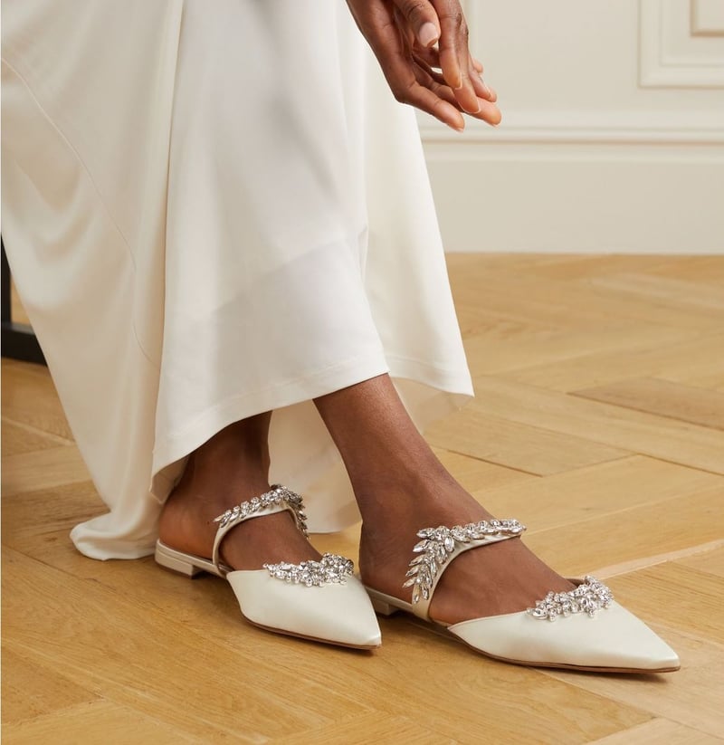 close up of a bride's flat wedding shoes with crystal detailing on the front and strap