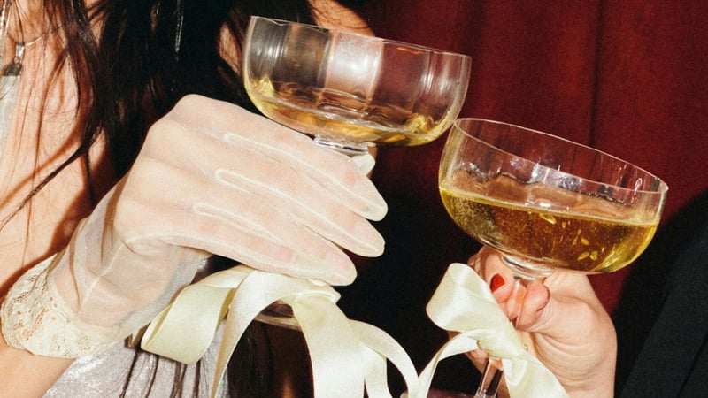 newlyweds cheersing retro champagne coupes together