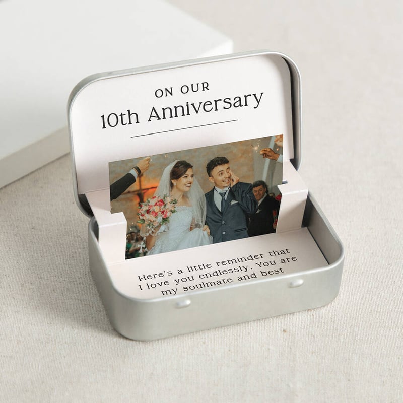open silver tin containing and image of a bride and groom and a special message for a 10th anniversary