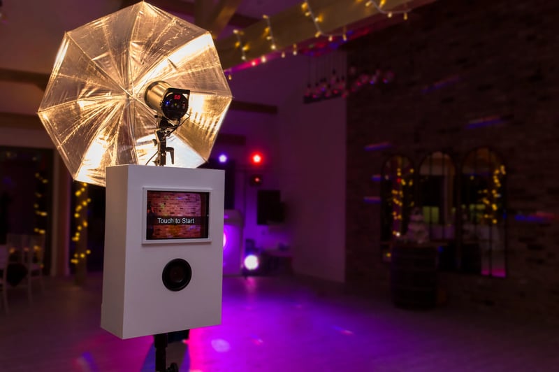 white wedding photo booth in a fairy light lit room