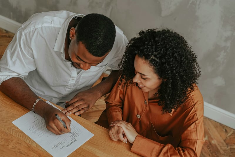 couple signing a prenuptial agreement