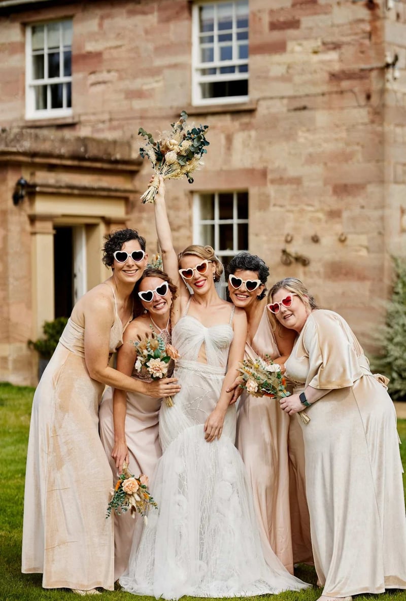 Bride and bridesmaids wearing heart shaped sunglasses