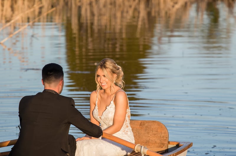 couple in a rowing boat on their wedding day 