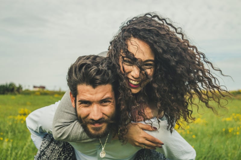 a man giving a woman a piggyback
