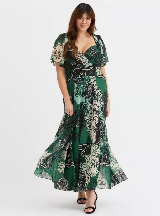 model wearing a summer wedding guest dress in green patterned design