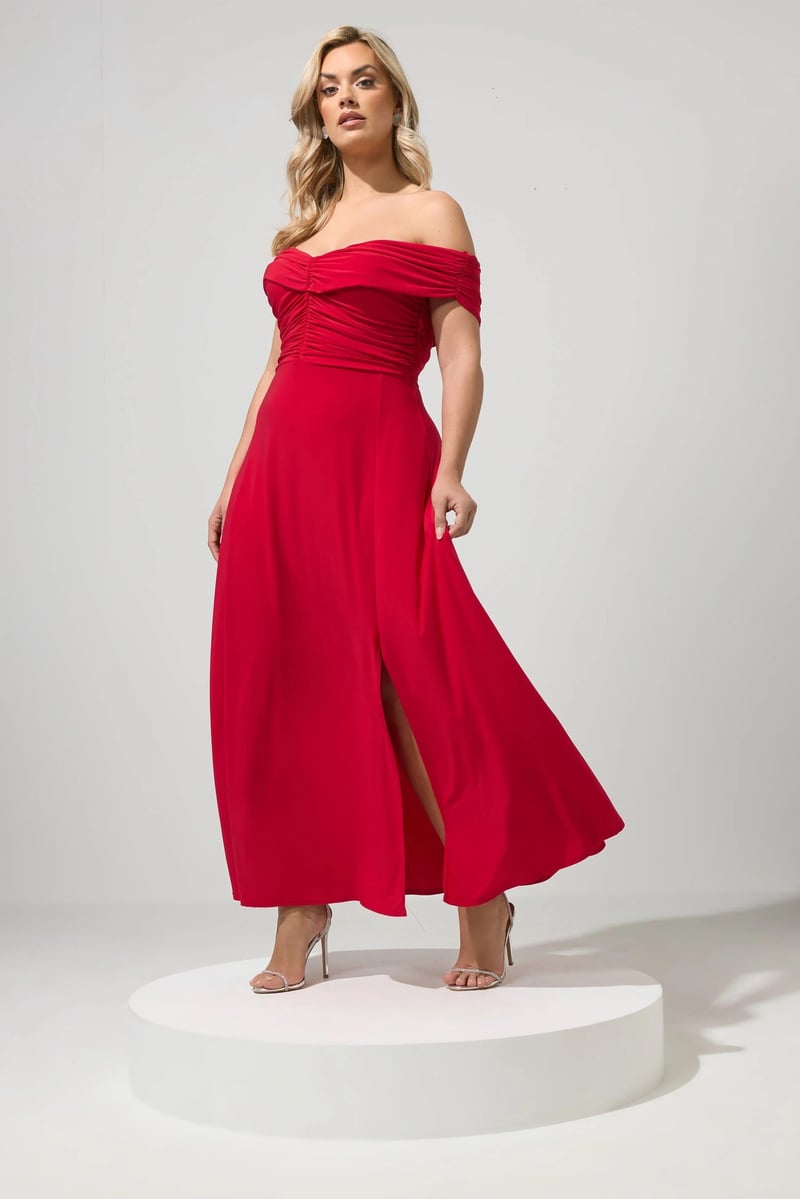 a curve model wears a red midi dress with Bardot neckline.