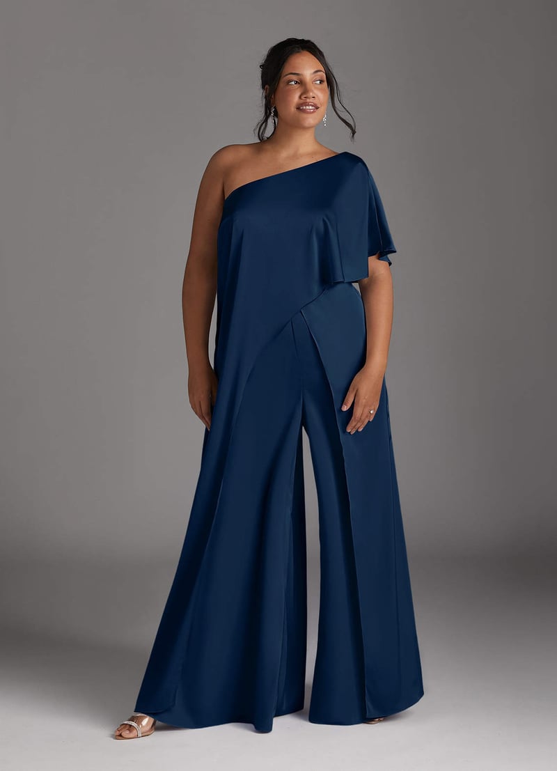 a plus size model wears a dark blue one shoulder jumpsuit with wide leg trousers.