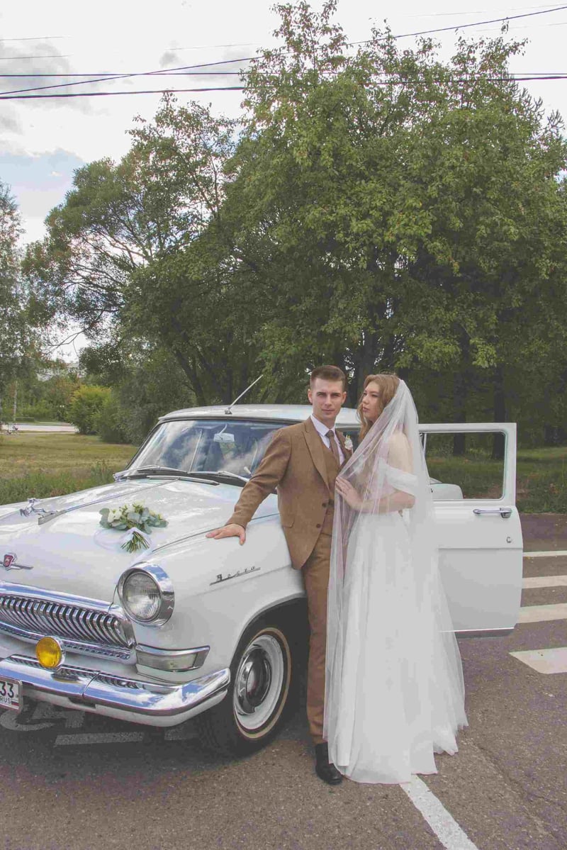 Bride and groom next to a vintage car in retro inspired outfits
