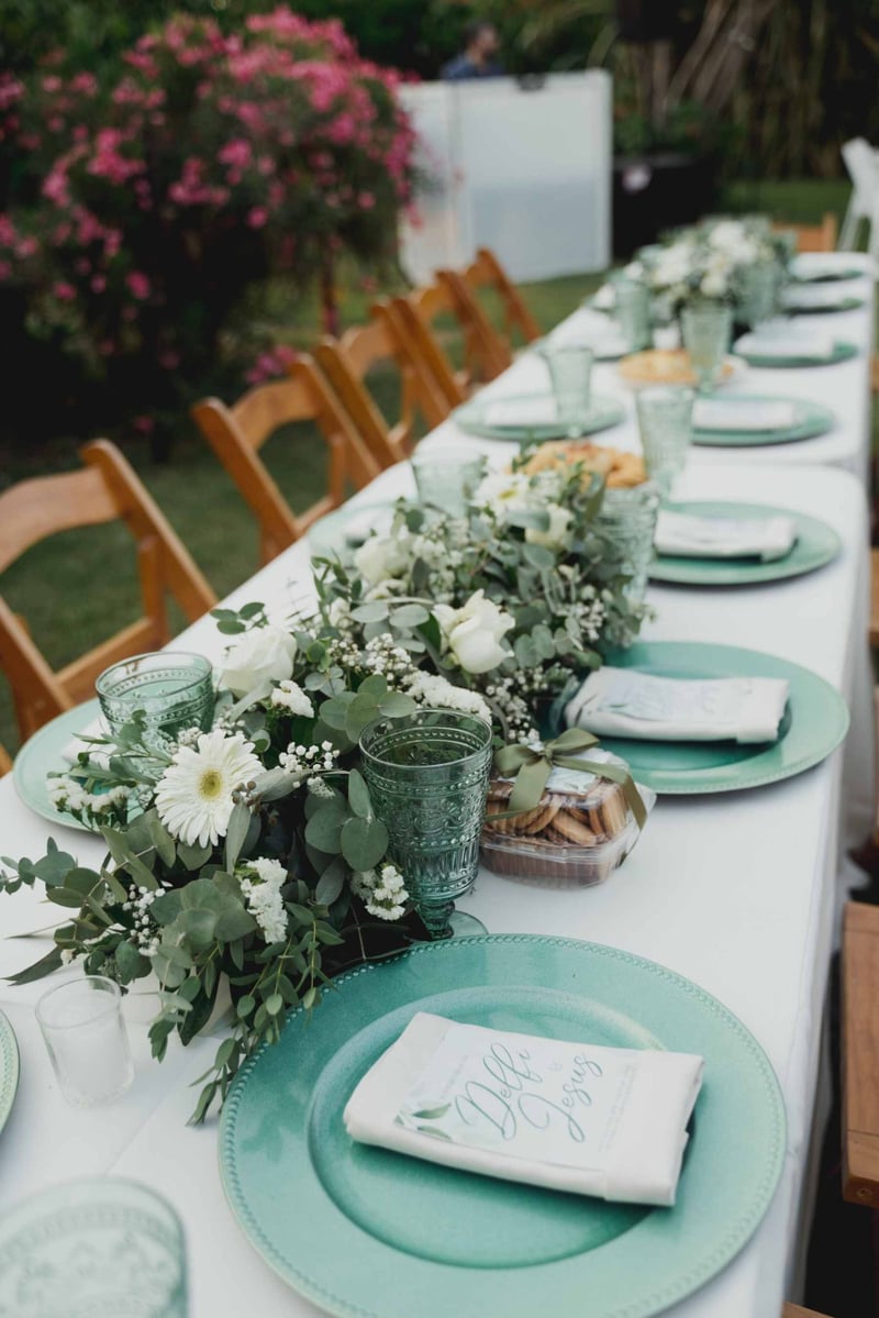 Green themed wedding reception table with green plates and florals