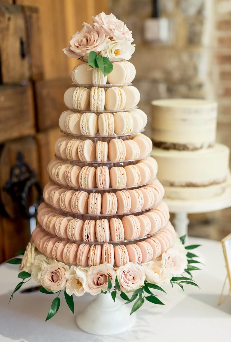 a tower of pink and white ombre macarons at a wedding