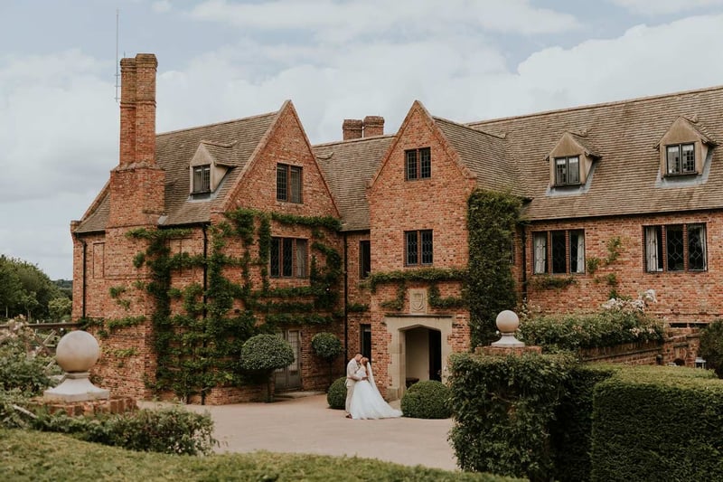 Bride and groom embracing outside of a wedding venue
