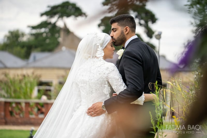 a bride and groom in a light embrace