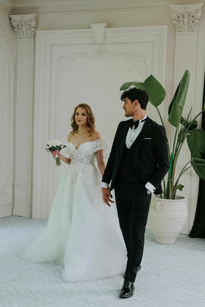 Bride and groom hand in hand at a black tie wedding