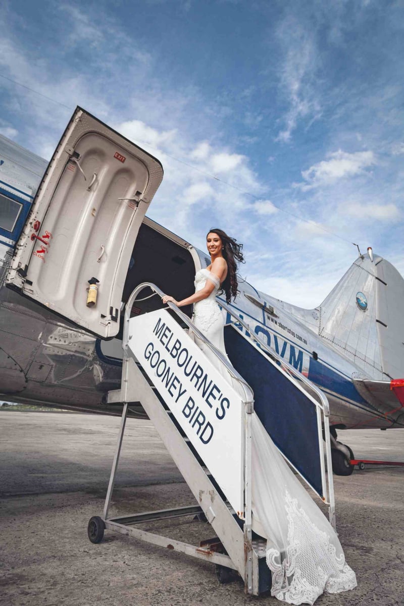 Bride in melbourne boarding a plane called Melbourne's Gooley Bird