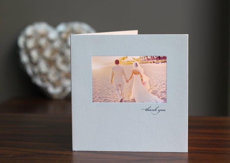 a wedding thank you card featuring a photo of the bride and groom.