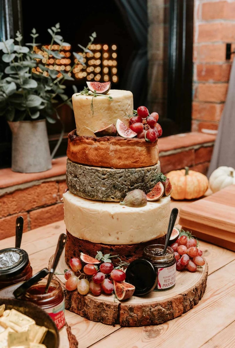 Stacked cheese wedding cake with figs and grapes