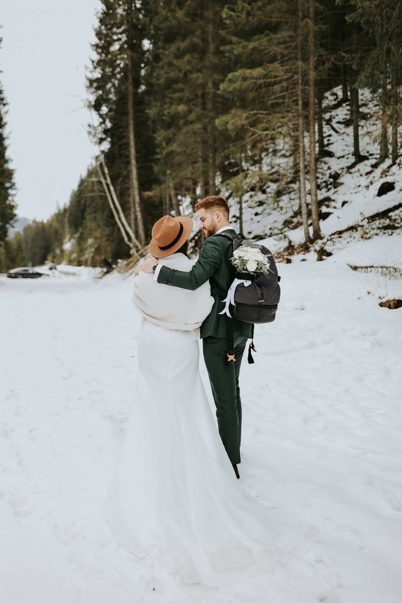 Bride and groom kissing in the snow at a canadian winter wedding
