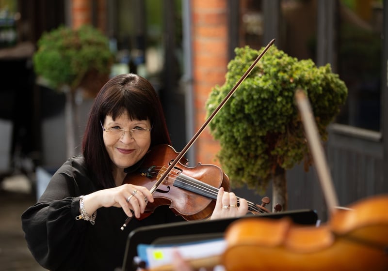 close up of a female musician playing as part of a string quartet.