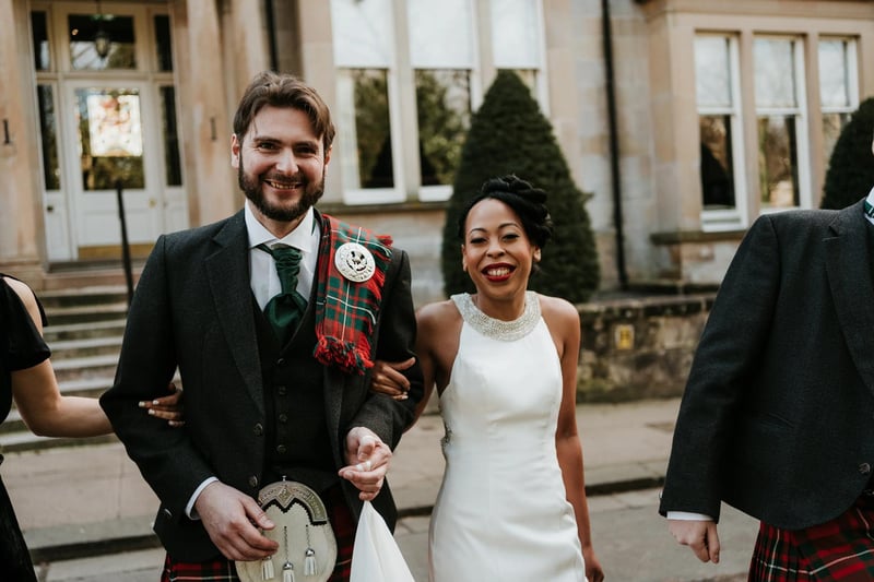 Bride and groom arm in arm at a scottish wedding