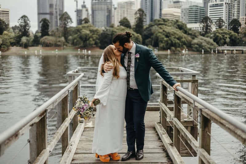 Bride and groom kissing on a dock in an Australian city