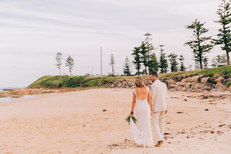 Bride and groom walking on a beach in Western Sydney, Australia