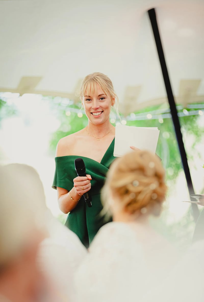 Bridesmaid in a green dress giving a maid of honour speech