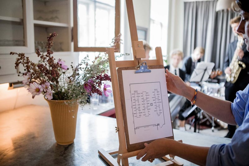 A woman working on a draft of a seating chart for a wedding