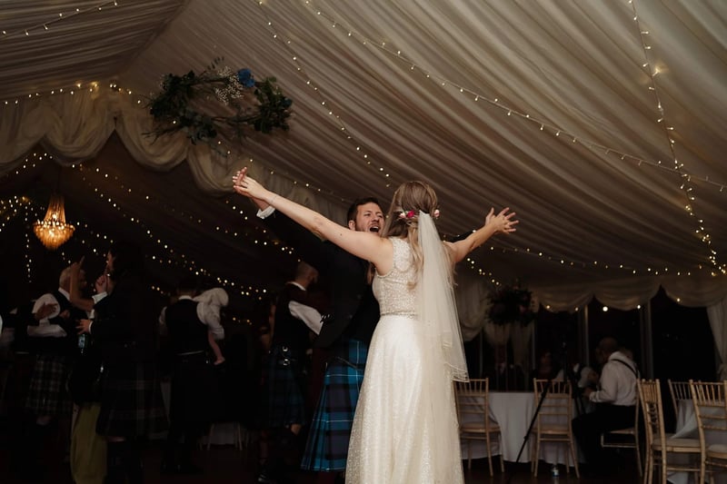 Bride and groom dancing in a ceilidh at a scottish wedding
