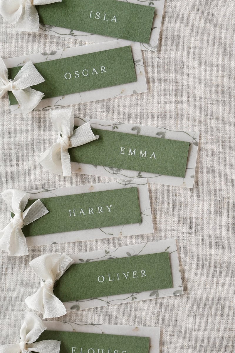 green and white place cards with pretty white bows.
