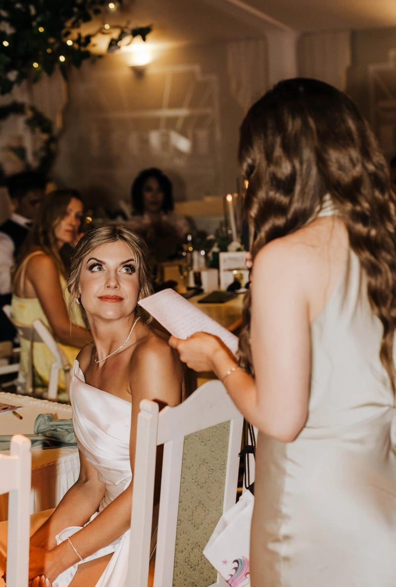 Bride looking on lovingly as a maid of honour gives a wedding speech